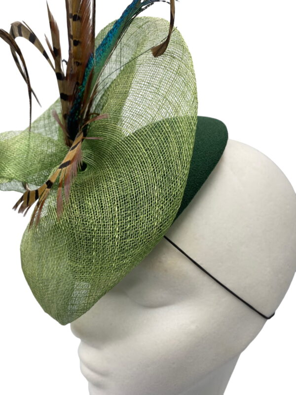 Green feathered headpiece with stunning feather detail.